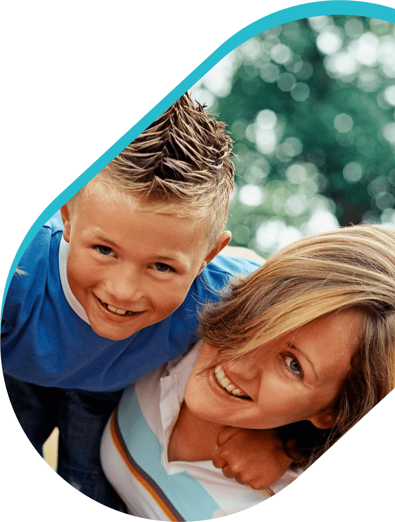 A woman and boy smiling for the camera.